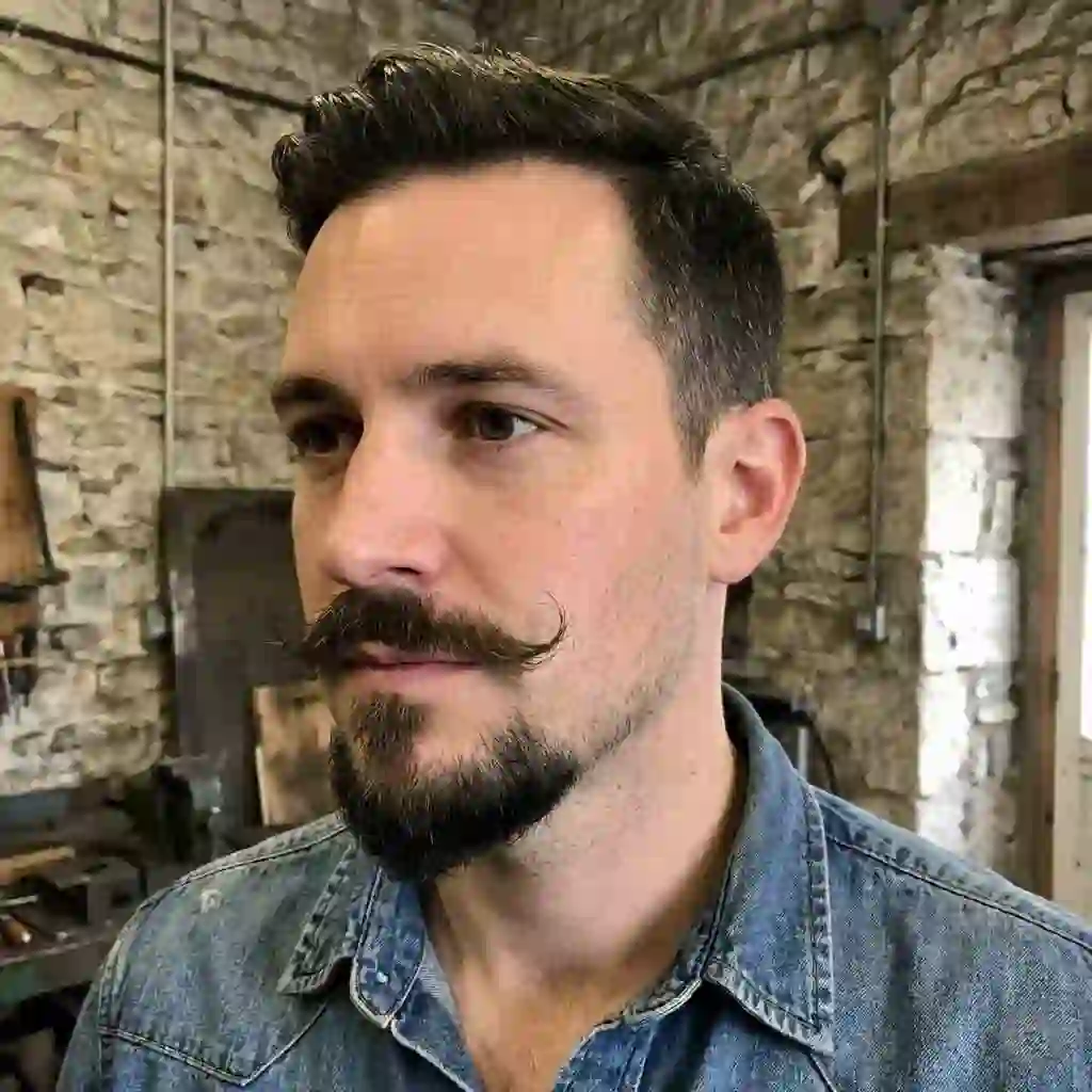 A disconnected Van Dyke beard style that avoids the cheek area entirely, making it a smart choice for the best beard for your face shape.