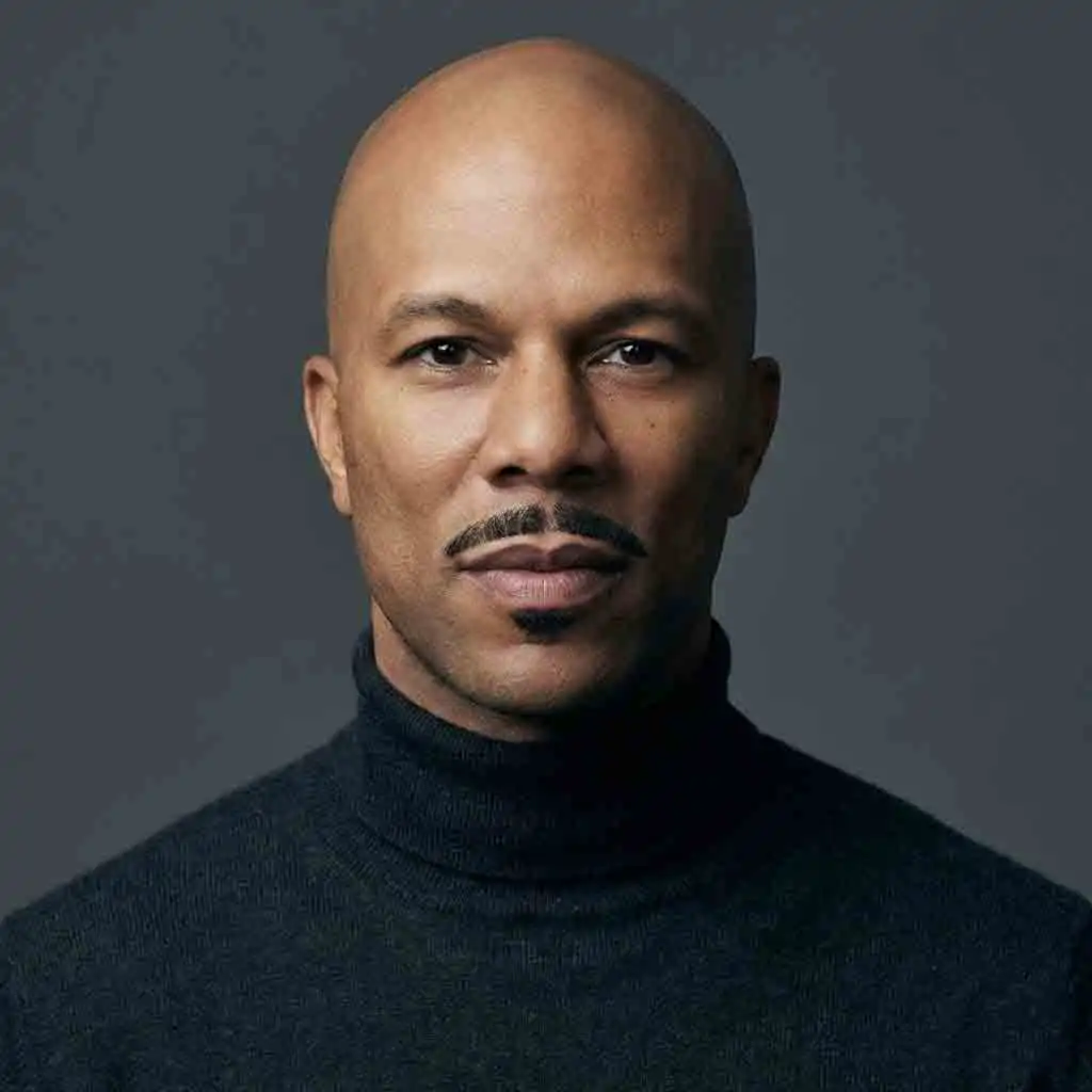 Common’s classic disconnected mustache paired with a clean-shaven head, minimalist lines, and pristine edges that emphasize intellectual style, cultural polish, and refined, iconic hip-hop grooming aesthetics.