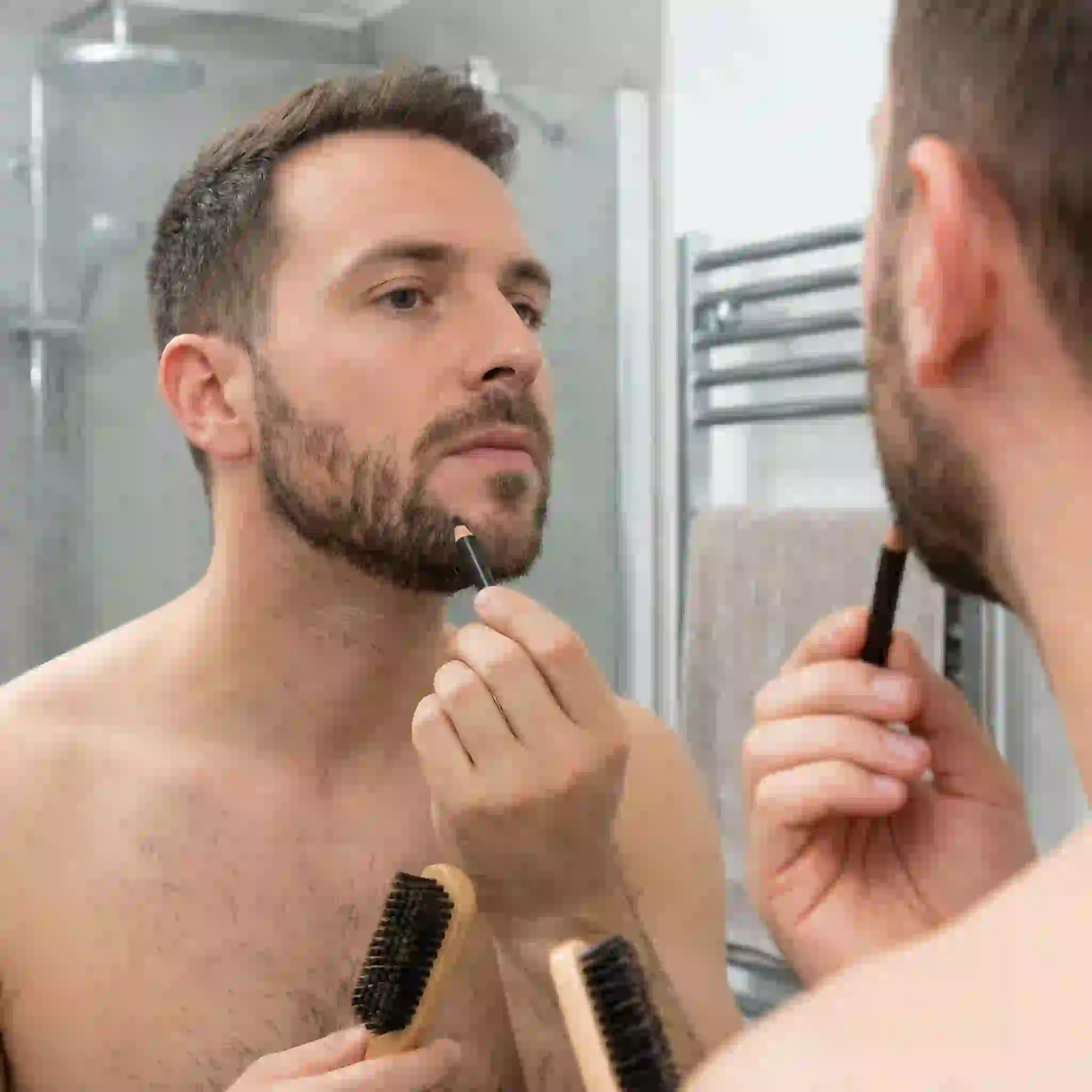 A beard filler pencil being used to cover small gaps, providing a quick cosmetic fix for those wondering how to remove patchy beard instantly.