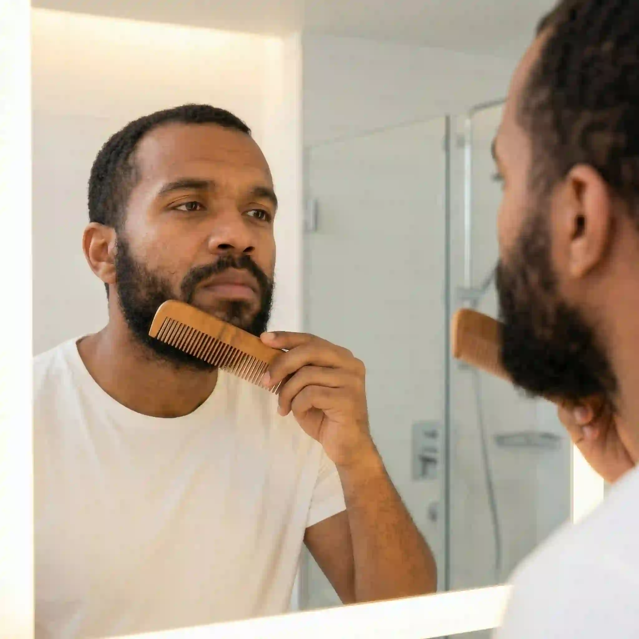 Thoroughly brushing your facial hair so it lies flat in the same direction ensures that your shaping template or beard liner tool sits perfectly flush against your skin for absolute precision.