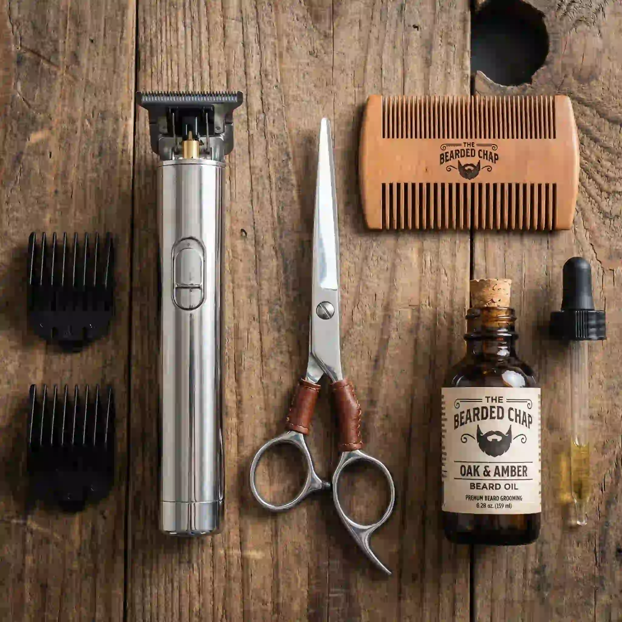 Essential grooming tools laid out to maintain perfect beard styles by face shape: professional clippers, styling scissors, comb, and soothing beard oil.