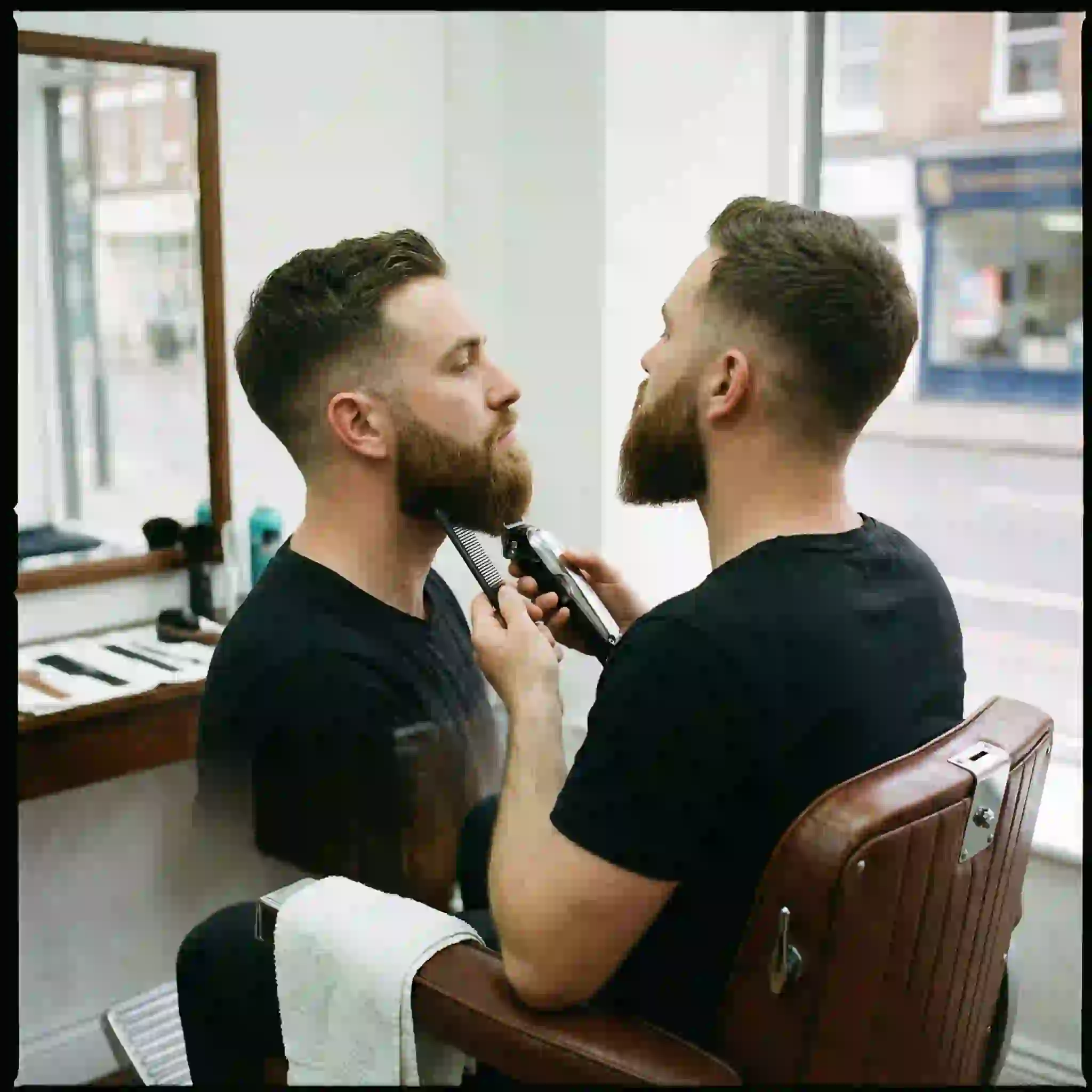 A section-by-section trimming guide for achieving professional beard styles by face shape at home using varying clipper lengths from sides to center chin.