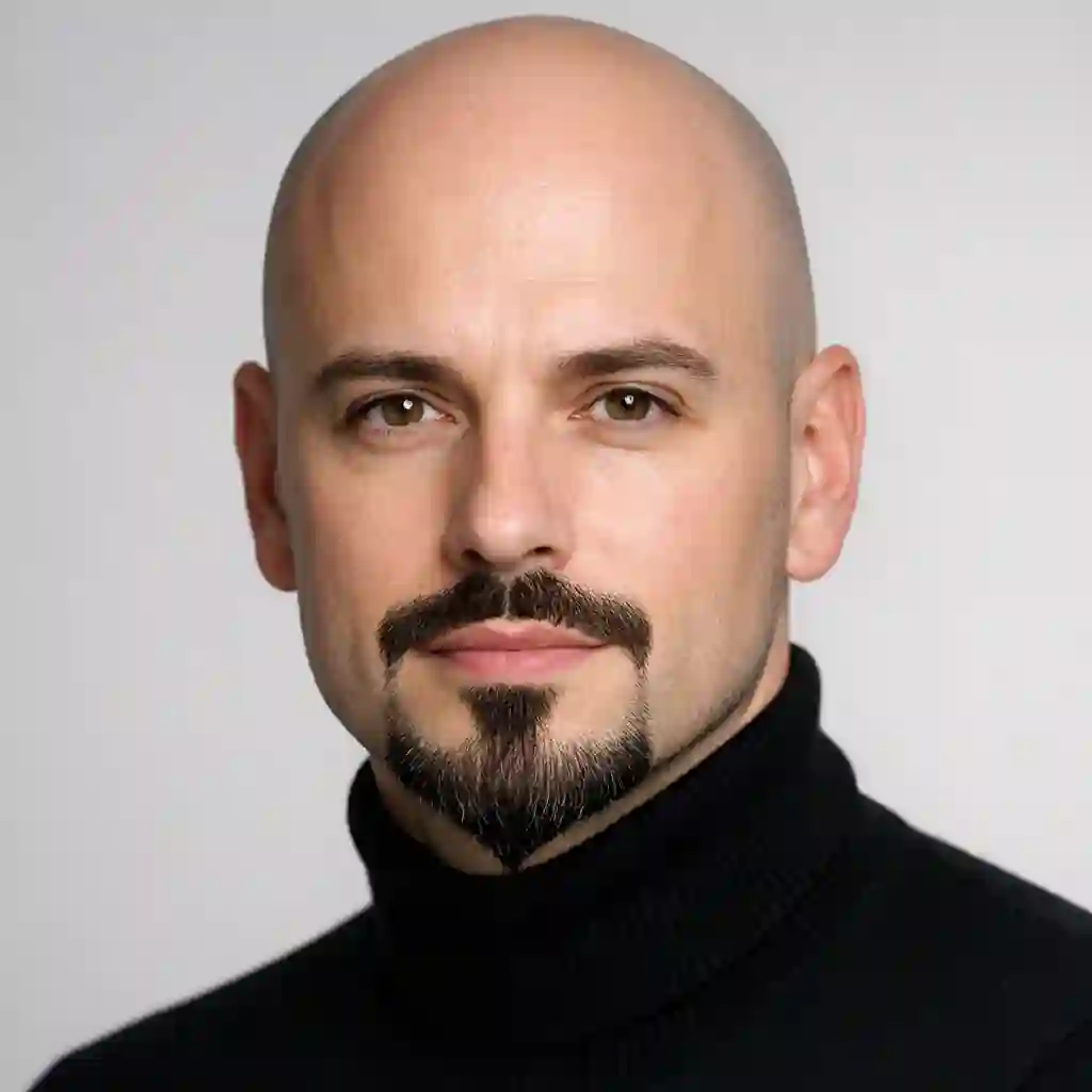 The artistic Van Dyke style features a disconnected mustache and chin beard, serving as a highly fashionable and sharp best beard for bald head that beautifully draws attention to the center of your newly sculpted face.