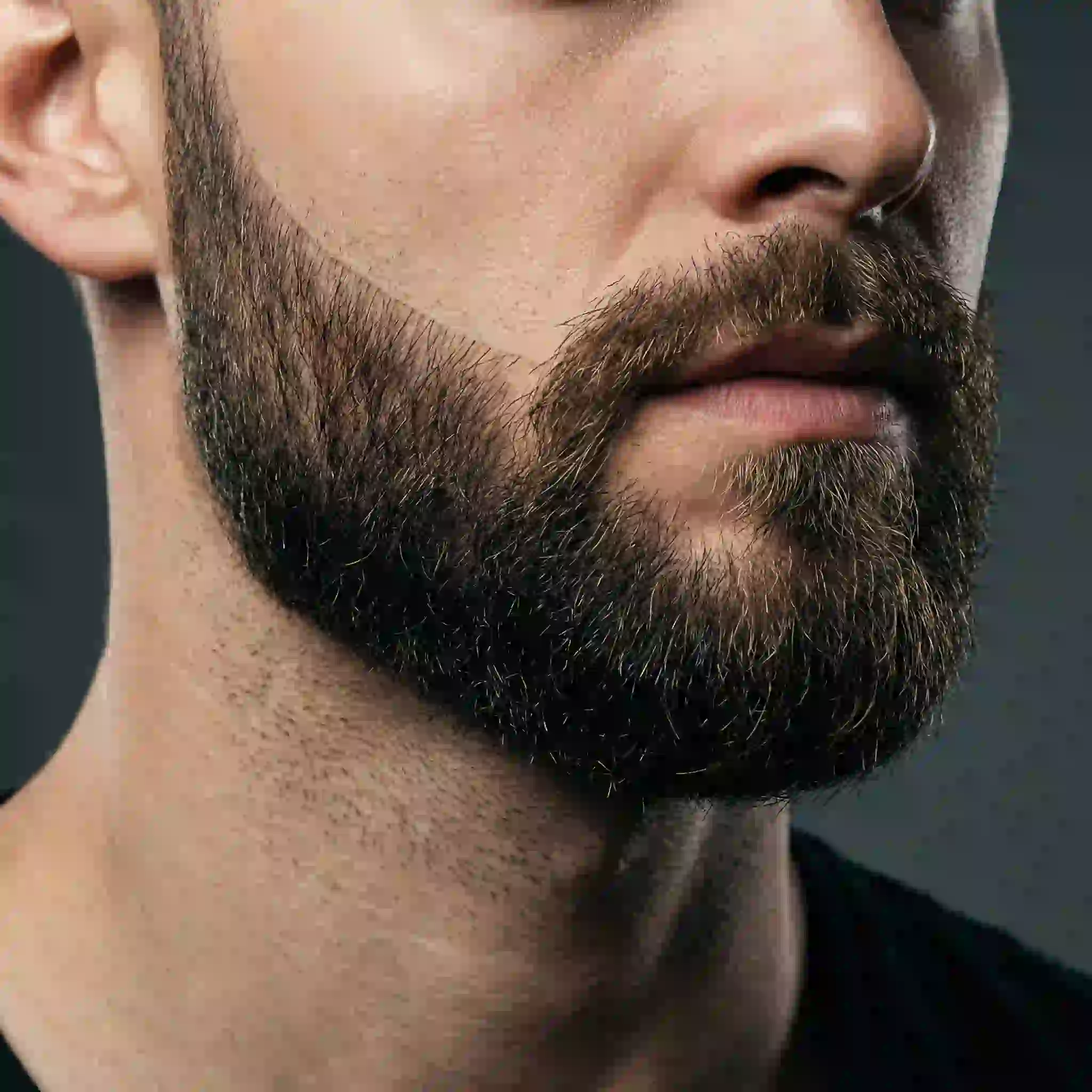 A perfectly groomed male face showcasing clean, sharp lines along the cheeks and neckline, demonstrating how targeted permanent beard removal can eliminate the need for daily shaping.